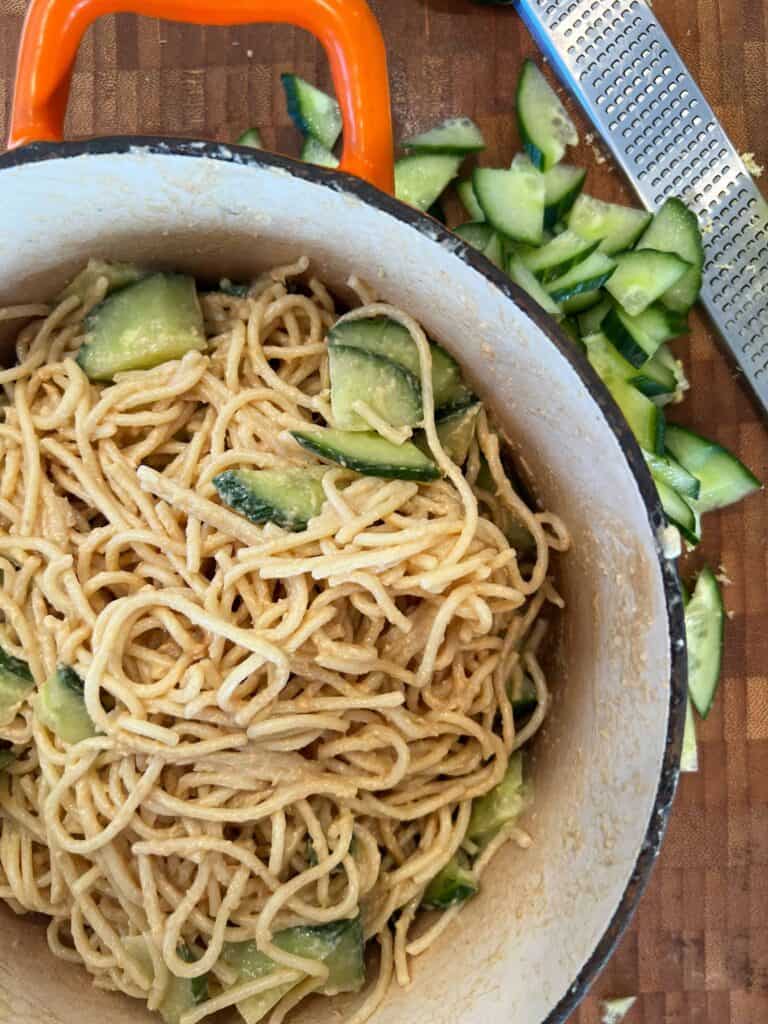 Add half the cucumber to the noodles