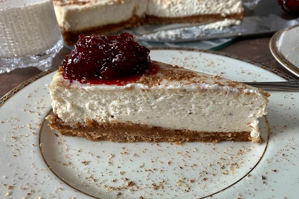 Eggnog Cheesecake with cranberry rum sauce