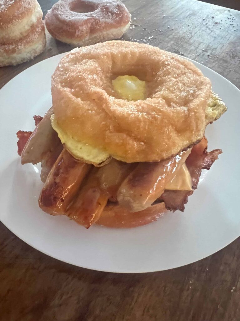 Mile-High Donut Breakfast Sandwich, with eggnog, bacon, sausage and cheese