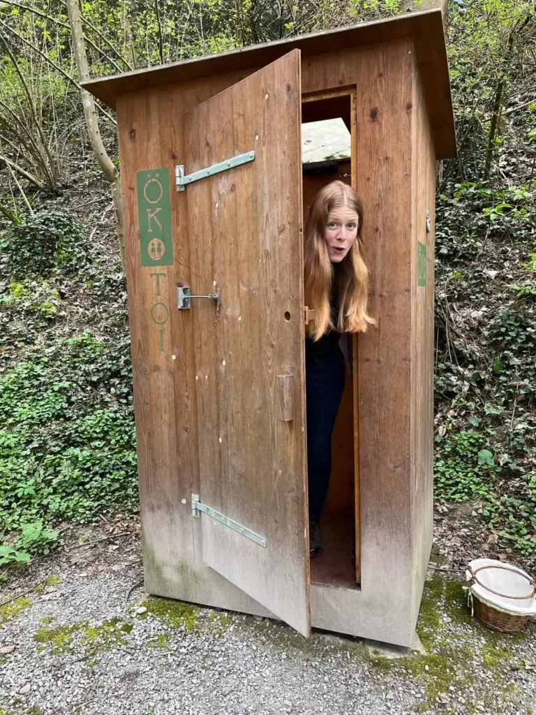Elke in a composting outhouse